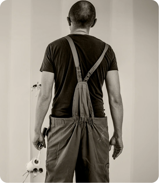 Professional painter applying a fresh coat to an interior wall with a roller